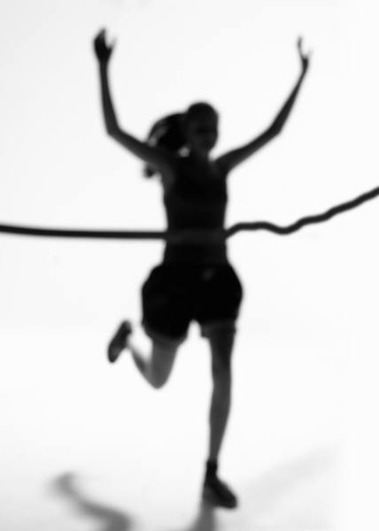 Image of a woman crossing the finish line