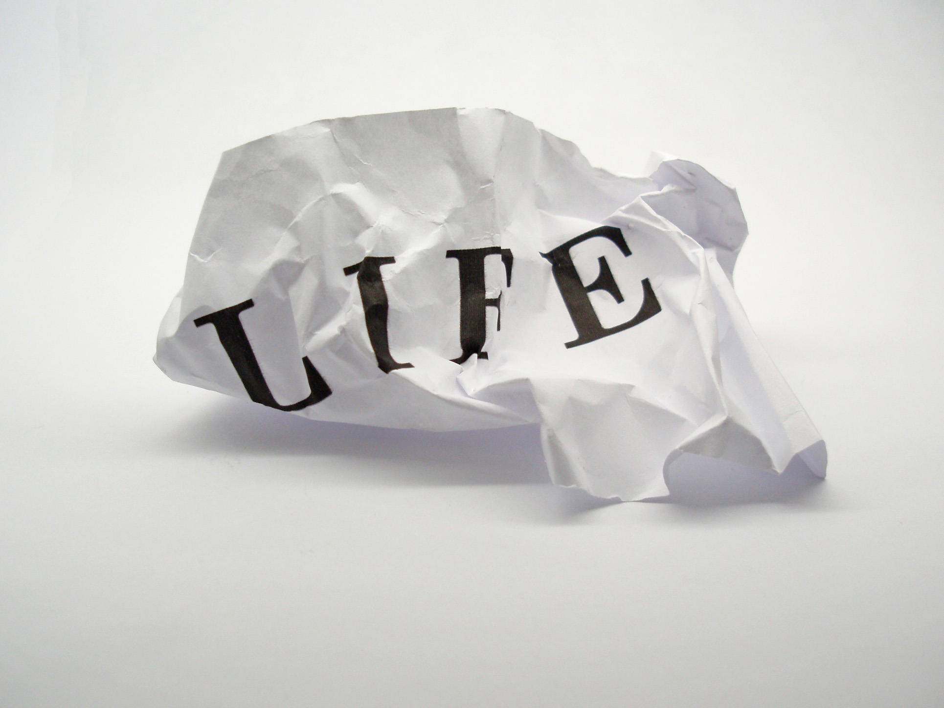 Life: crumpled paper with the word, 'life' printed on it.