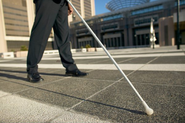 Blind person using a long white cane