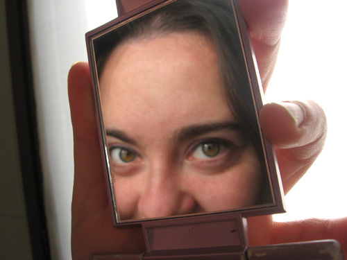 woman looking in mirror