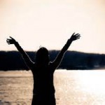 Woman with arms raised and hands open