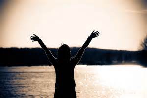 Woman with arms raised and hands open