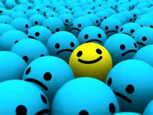 A bunch of blue frowny faces and one yellow smiley face