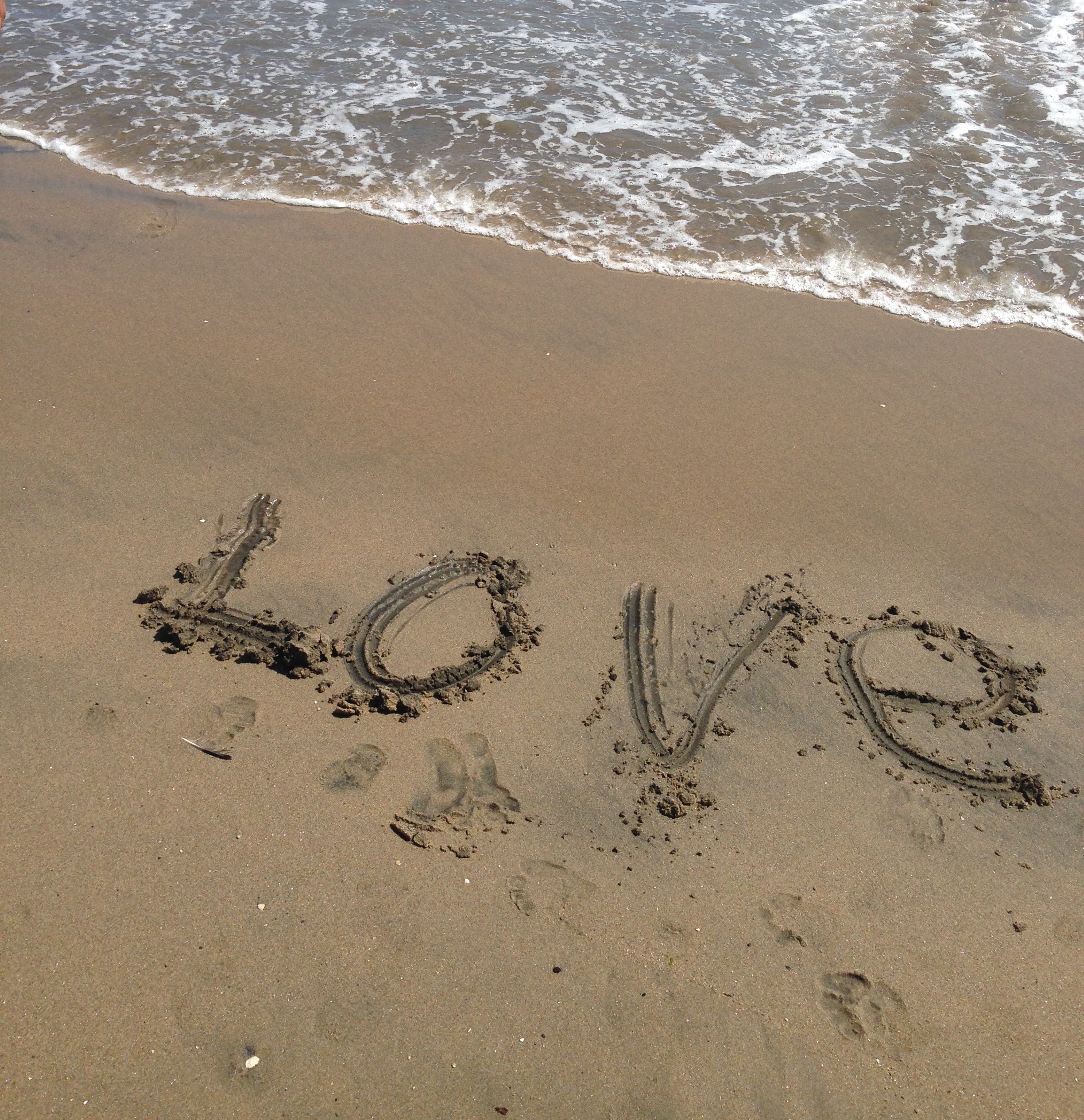 The word "love" written in the sand