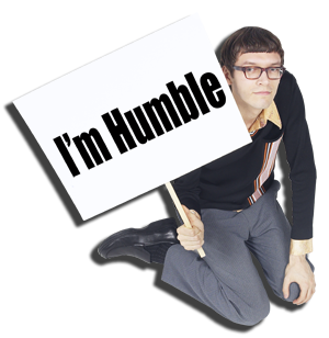 Man holding a sign that says , "I'm humble"