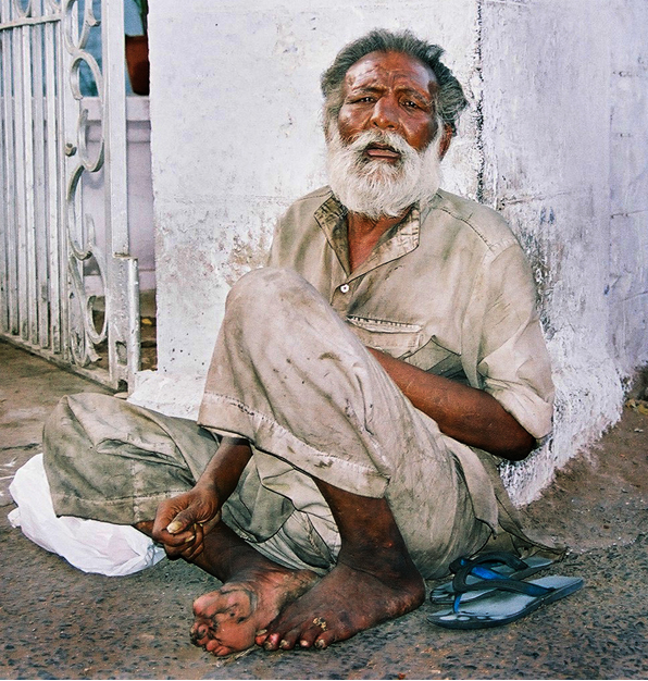 man begging and receiving charity