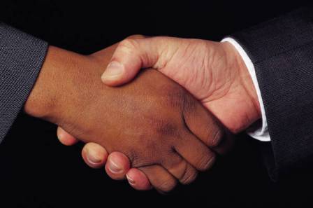 People of different skin color shaking hands.