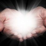 Hands holding light representing a miracle.